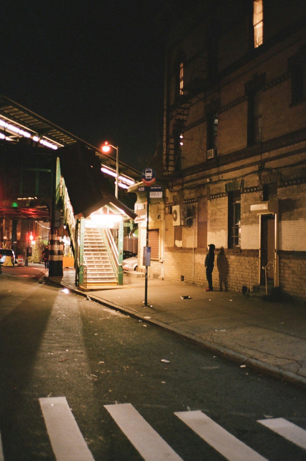 people walking on sidewalk during night time