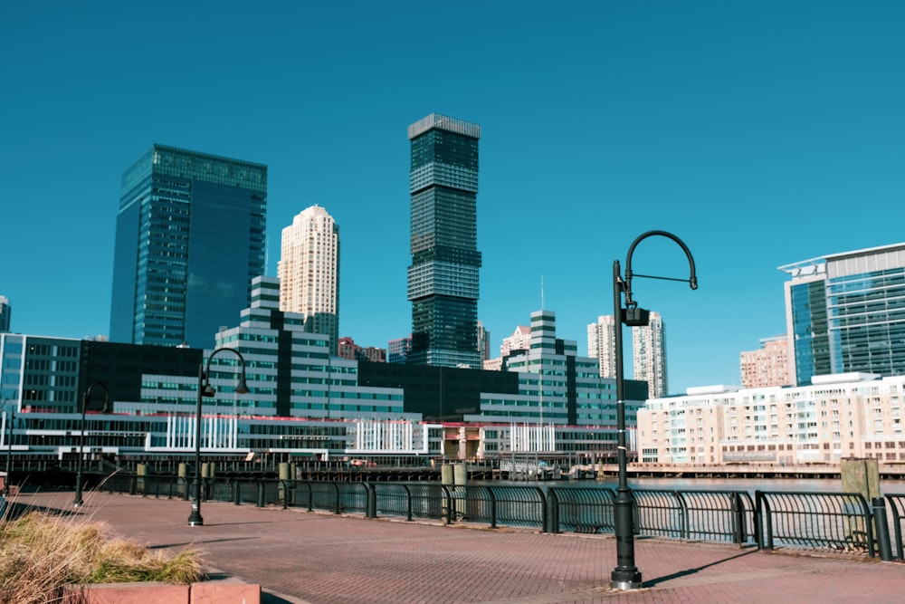 people walking on sidewalk near city buildings during daytime