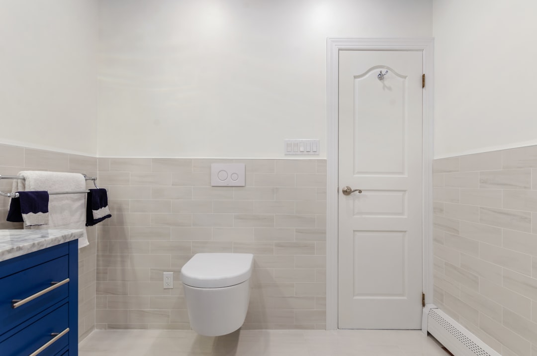 white ceramic toilet bowl beside white ceramic toilet bowl