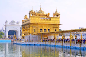 The Golden Temple in Amritsar with a crowd on the walkway over water