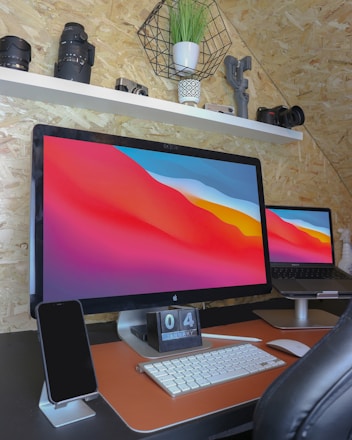 A sleek modern workspace with various tech gadgets including smartphones, laptops, and cameras.