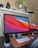 A vibrant workspace featuring modern tech gadgets and accessories on a sleek desk.