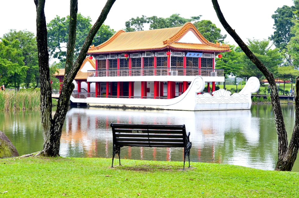 brown wooden bench near body of water during daytime