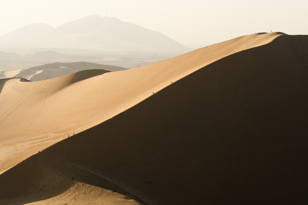 brown sand field during daytime