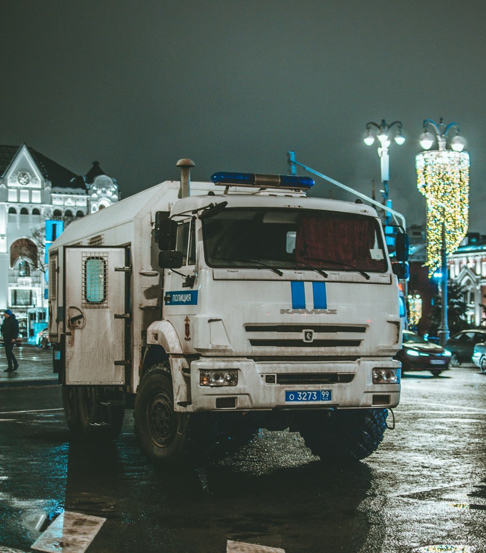 white and blue truck on road during daytime