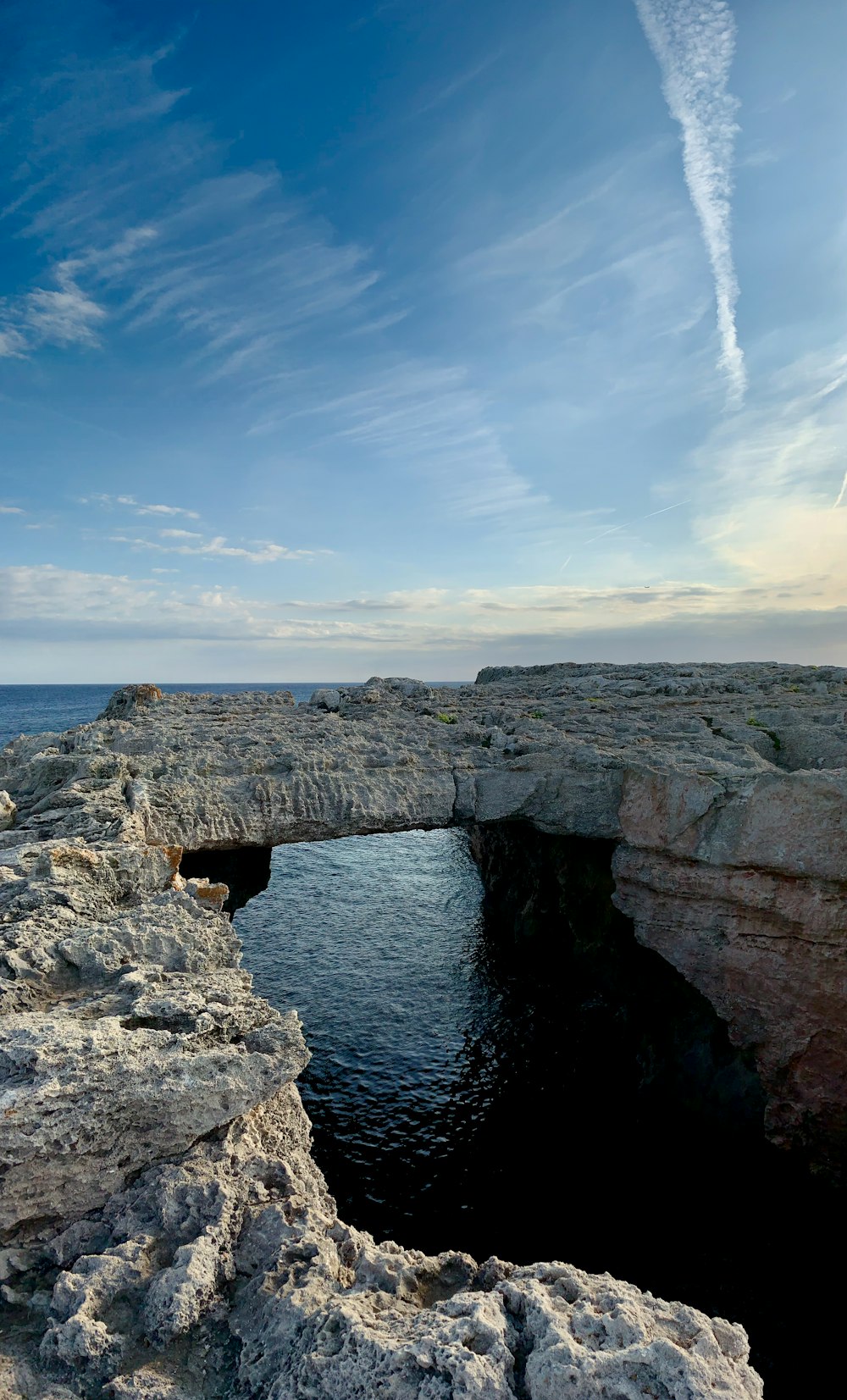 gray rock formation near body of water during daytime