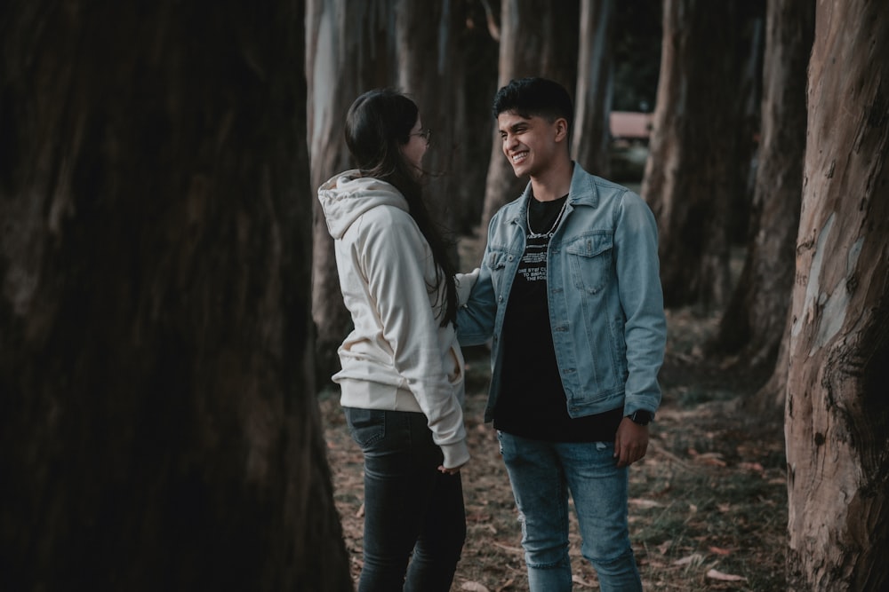 man in gray jacket and blue denim jeans standing beside man in gray jacket