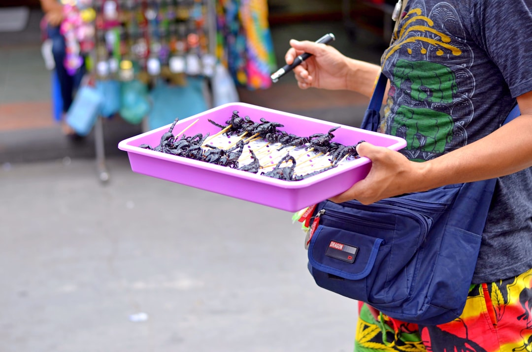 person holding purple plastic container with chocolate cake,