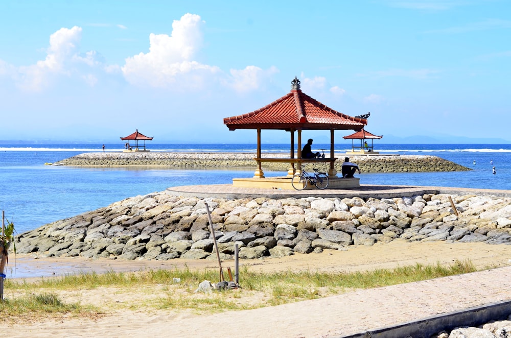 red and brown wooden beach cottage on beach shore during daytime