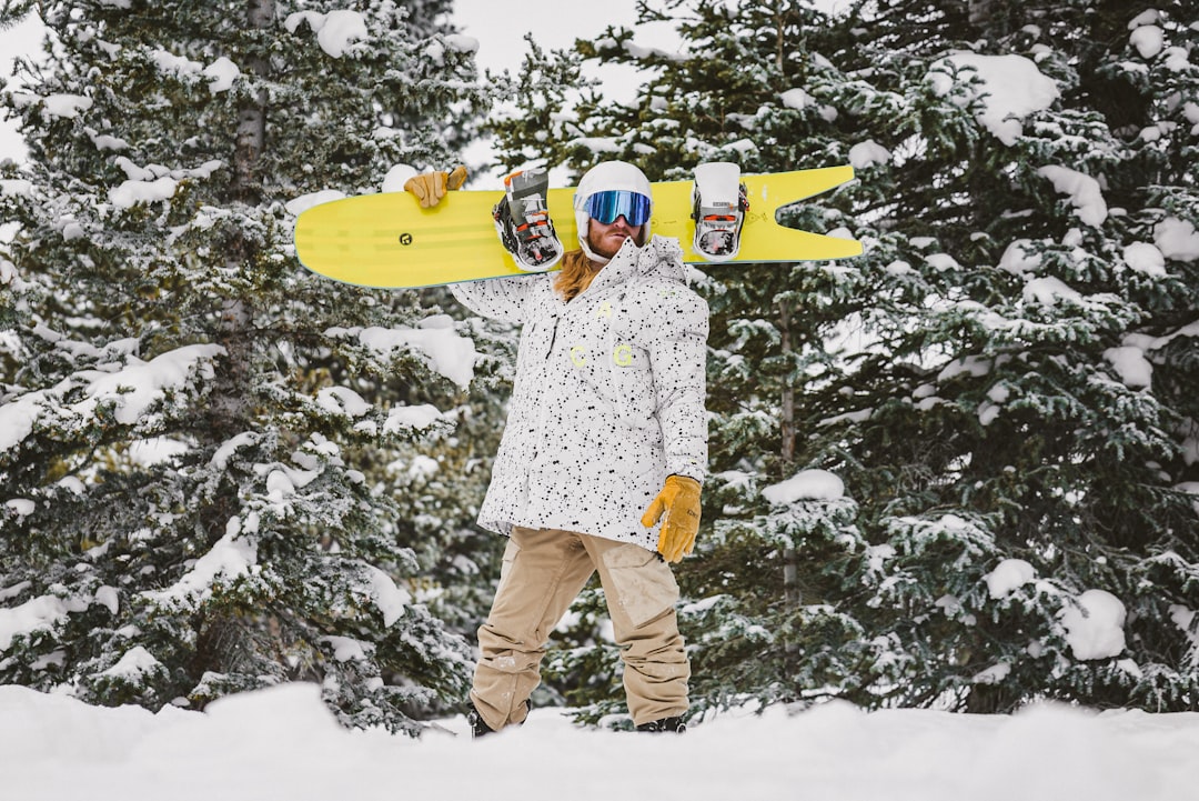 man in white and red floral dress shirt and brown pants holding yellow surfboard, Winter Wonderland