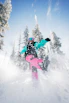 person in blue jacket and pink pants riding on snowboard during daytime