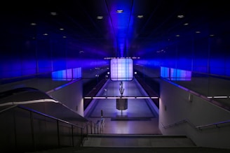 A bustling Saudi metro station with futuristic design and green accents.