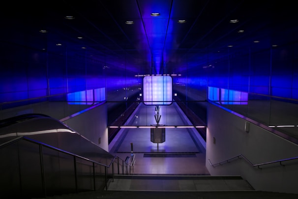 A bustling Saudi metro station with futuristic design and green accents.