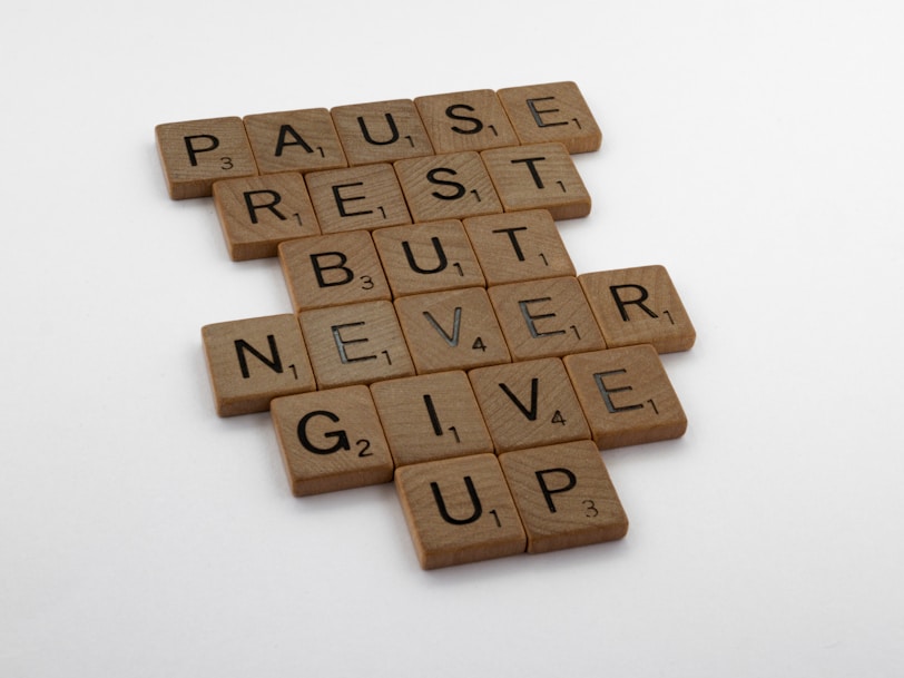 brown wooden blocks on white surface quote