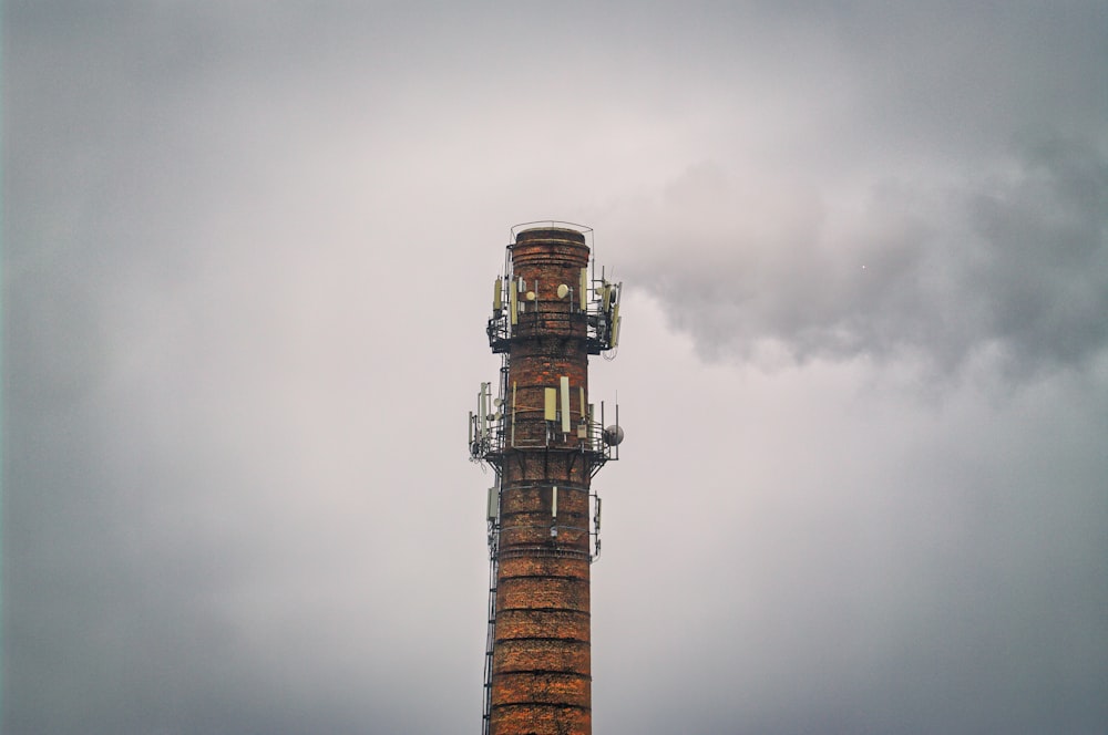 brown and black tower under cloudy sky