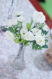 An elegant arrangement of spray roses in a glass vase.