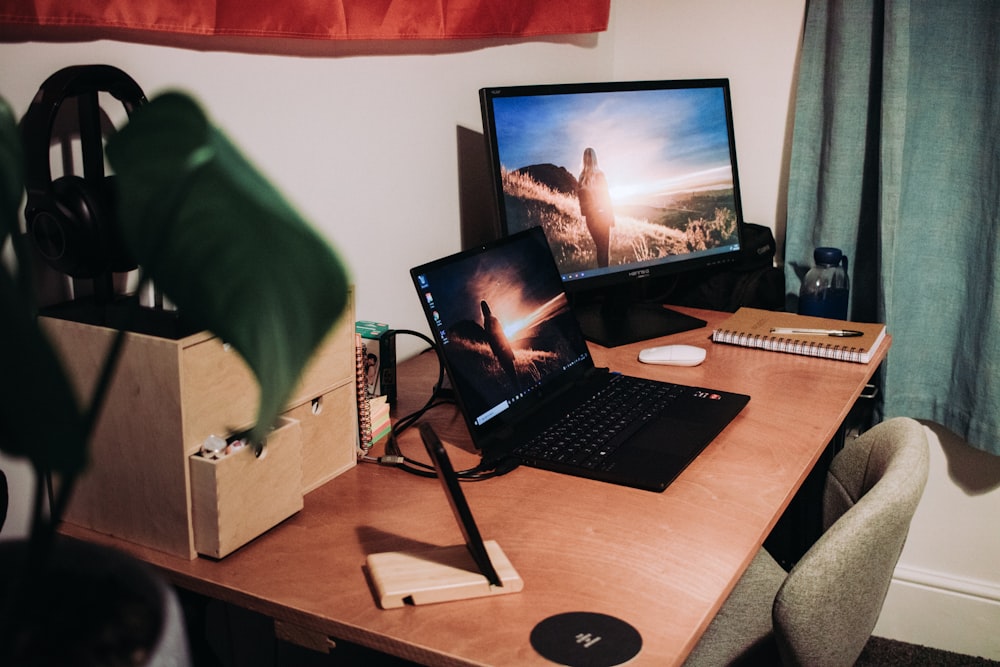 black laptop computer on brown wooden table