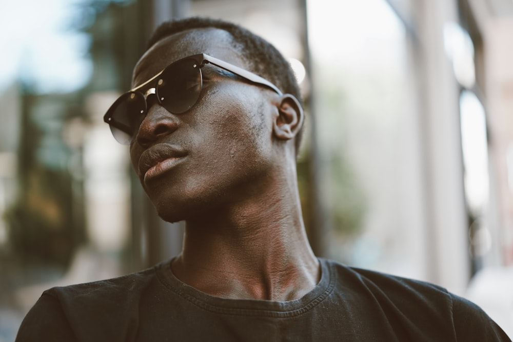 man in black crew neck shirt wearing black sunglasses