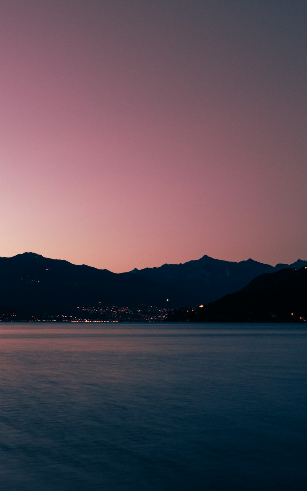 a large body of water with mountains in the background