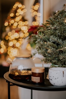 A cozy holiday scene featuring festive ornaments and themed mugs on a wooden table.