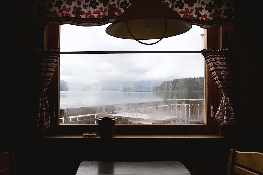 brown wooden table near window