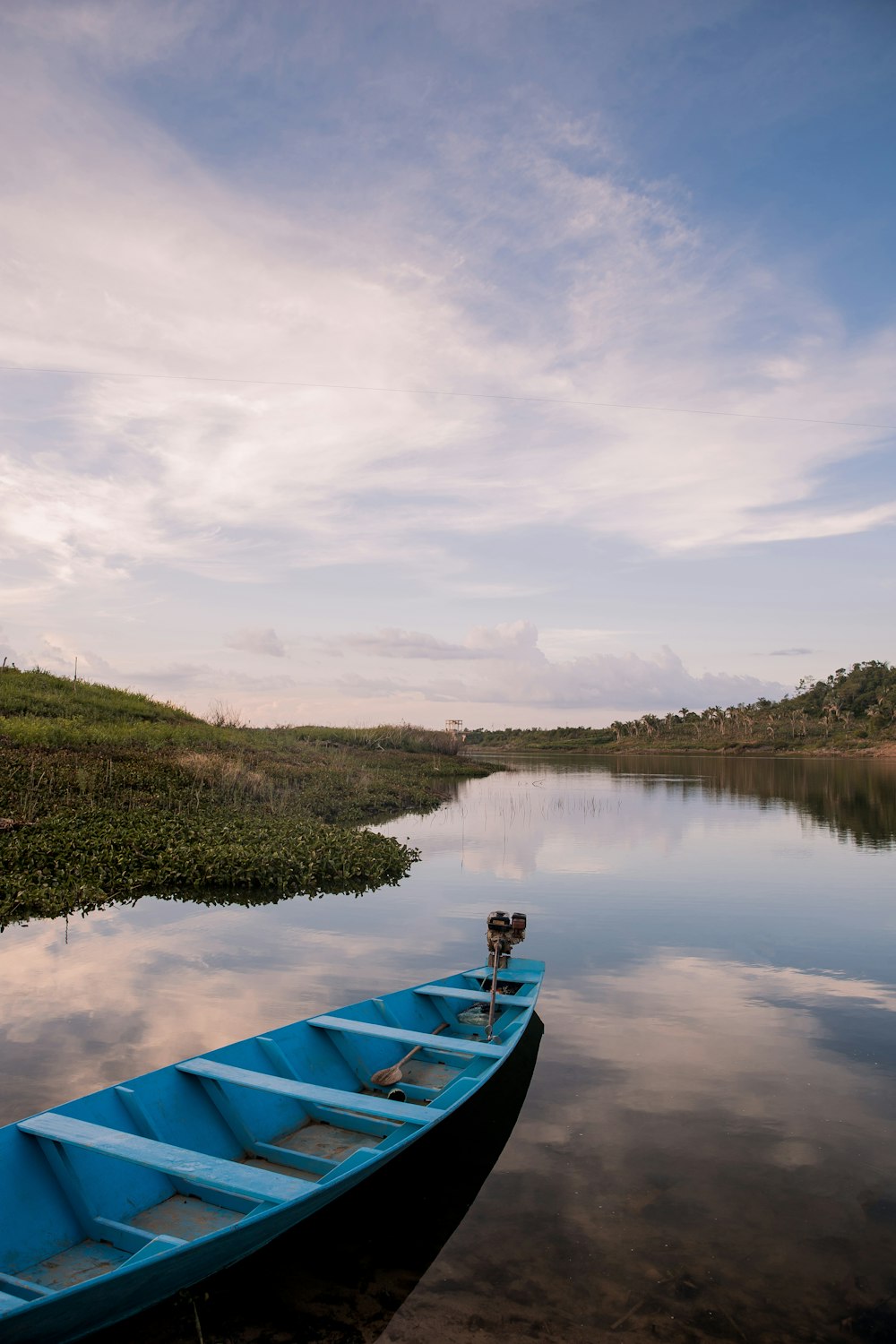 blue boat on lake during daytime