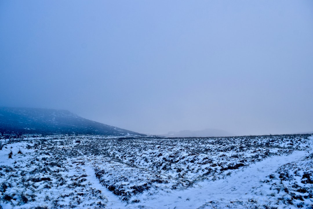 snow covered mountain under gray sky