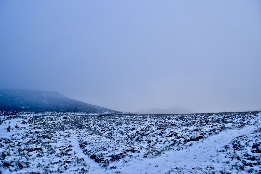 snow covered mountain under gray sky