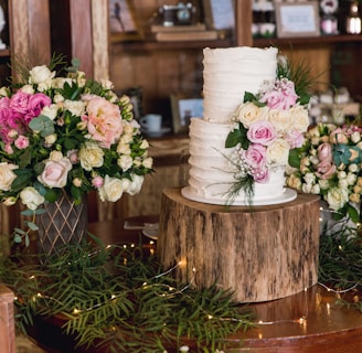 white and pink flowers on brown wooden round table