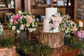 white and pink flowers on brown wooden round table