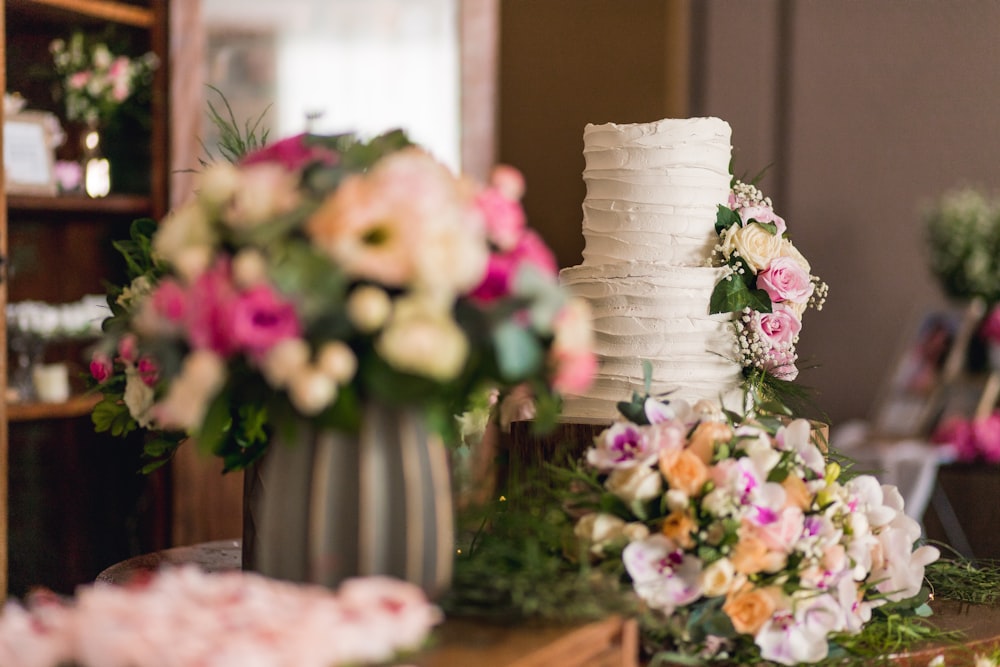 white and pink flowers on white ceramic vase