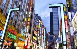 man in black jacket standing in front of high rise building during daytime