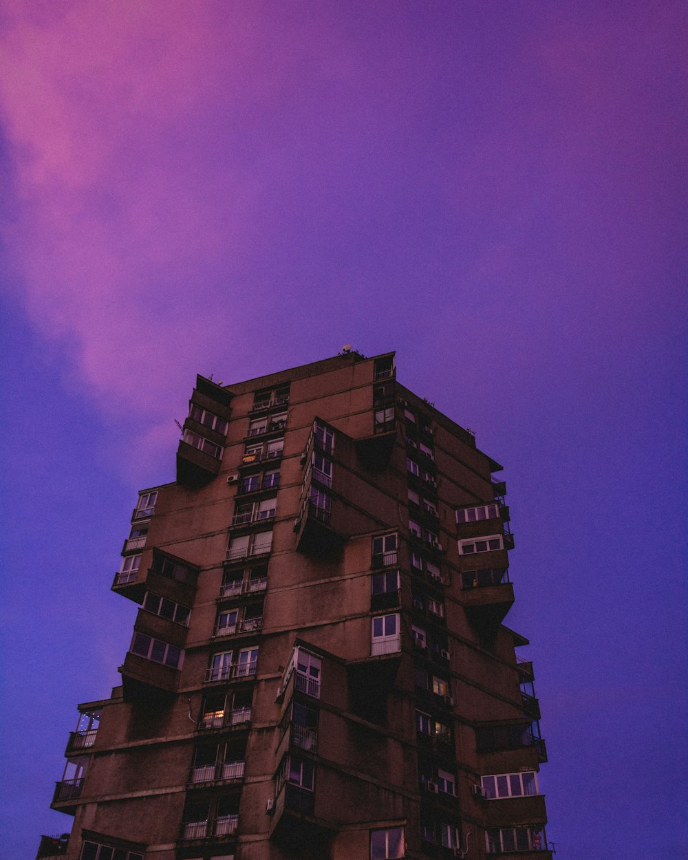 brown concrete building under purple sky