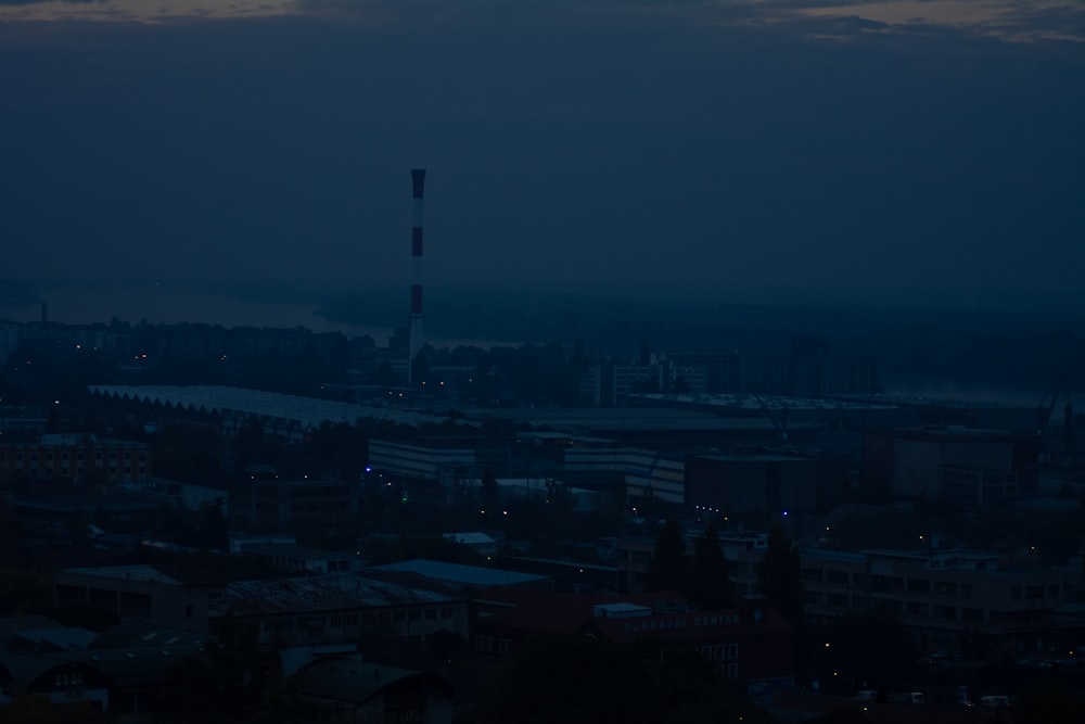 city skyline under gray sky during night time