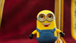 A playful mascot character from gameclown’s latest game waving cheerfully against a bright background.