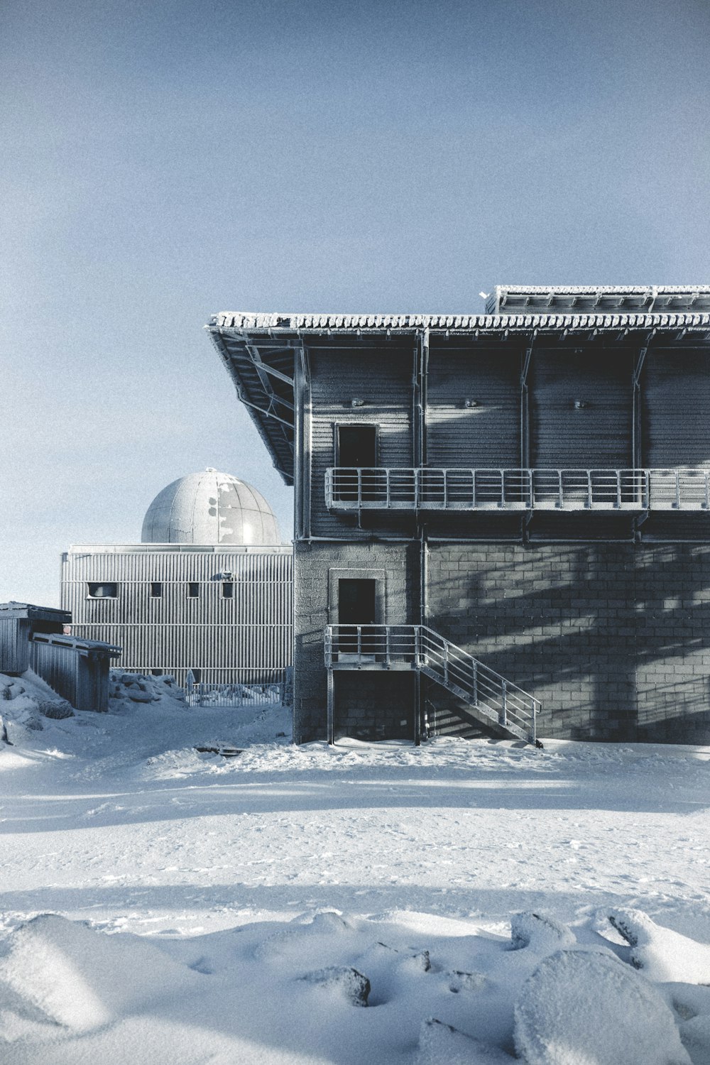 white and gray building on snow covered ground during daytime