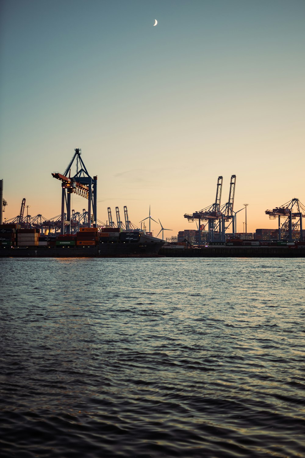 silhouette of crane near body of water during daytime