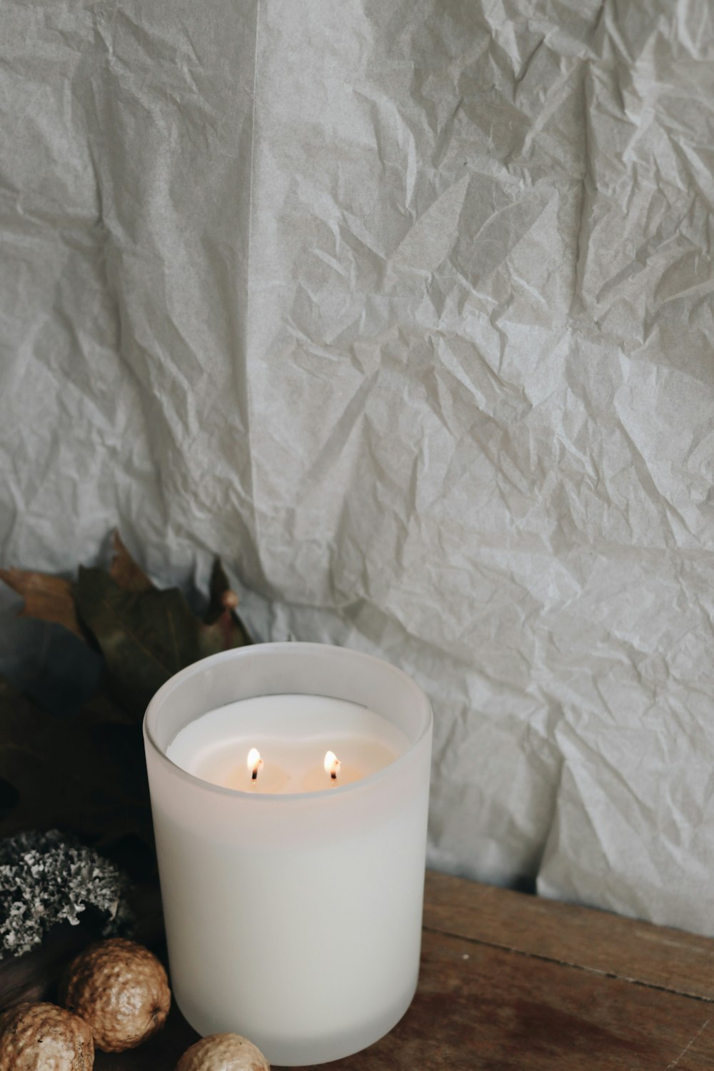 white pillar candle on black and white ceramic holder