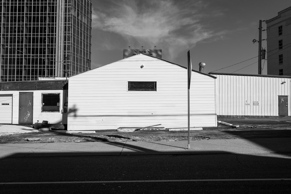 grayscale photo of building under cloudy sky