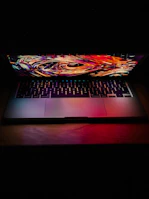 A sleek laptop screen showing a complex AI algorithm visualization in bright colors