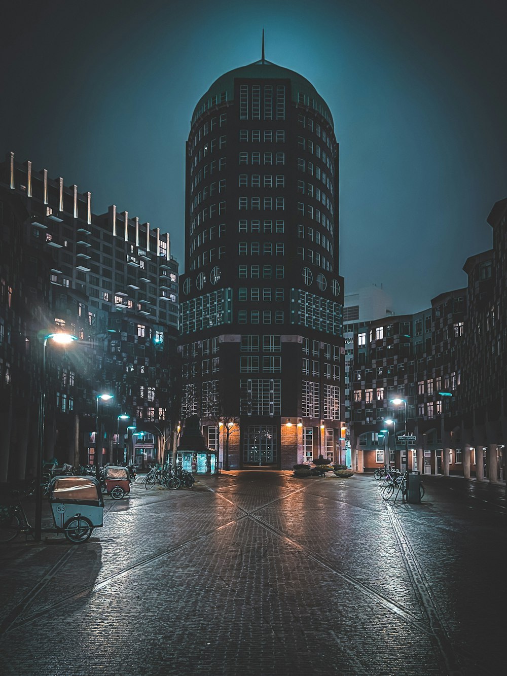 people walking on sidewalk near high rise buildings during night time