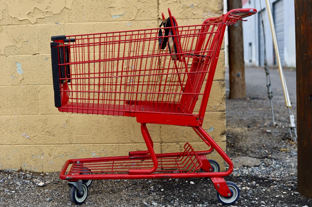 red shopping cart on gray concrete floor