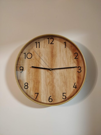 brown wooden round wall clock at 10 00
