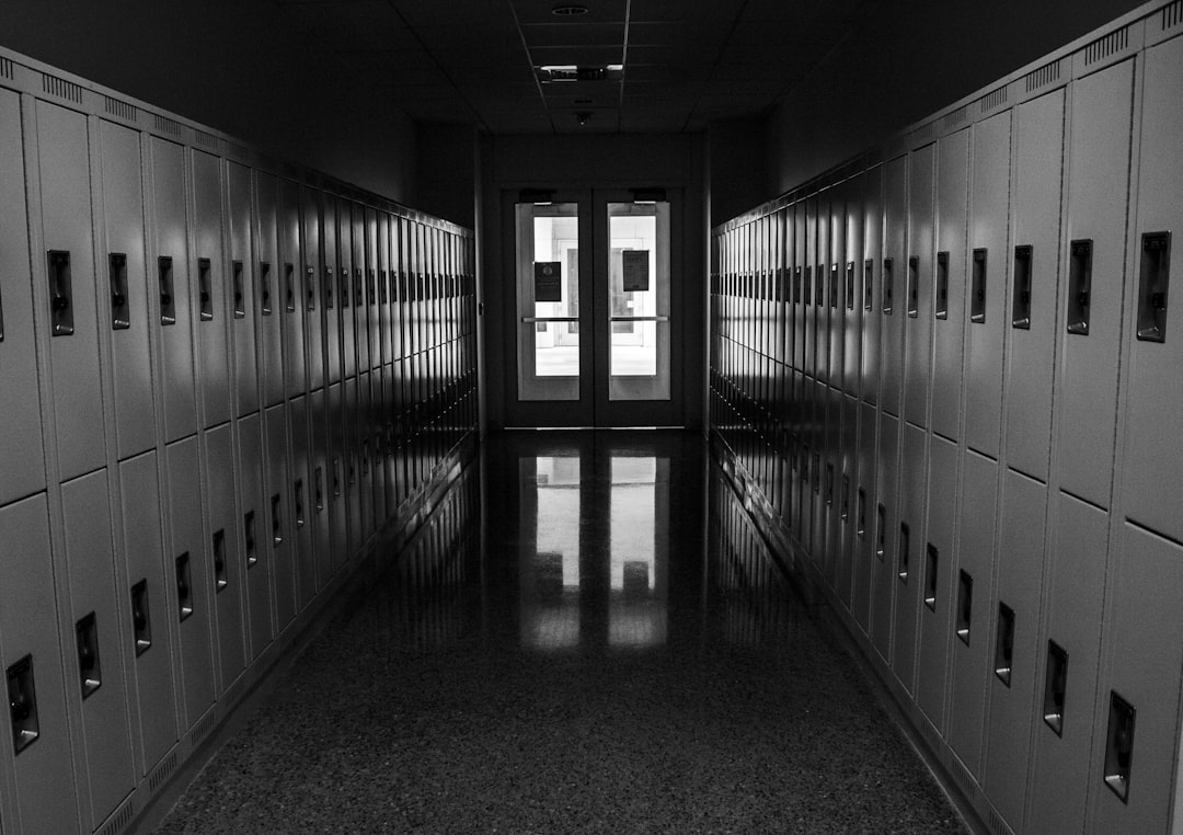 grayscale photo of hallway with lights turned on in the middle