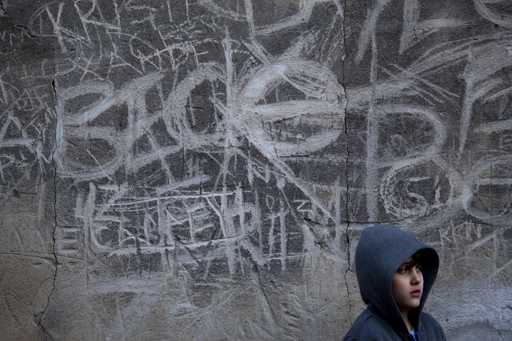 woman in black hijab near gray wall