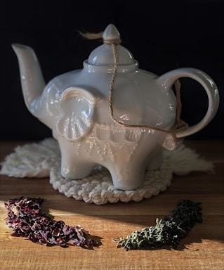 white ceramic teapot on brown wooden table