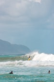 person surfing on sea waves during daytime