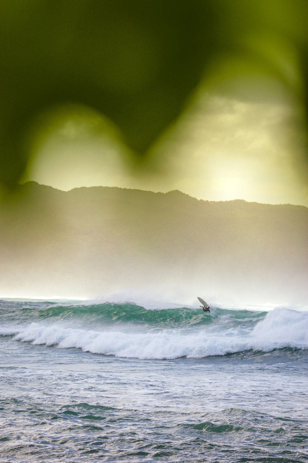 person surfing on sea waves during daytime