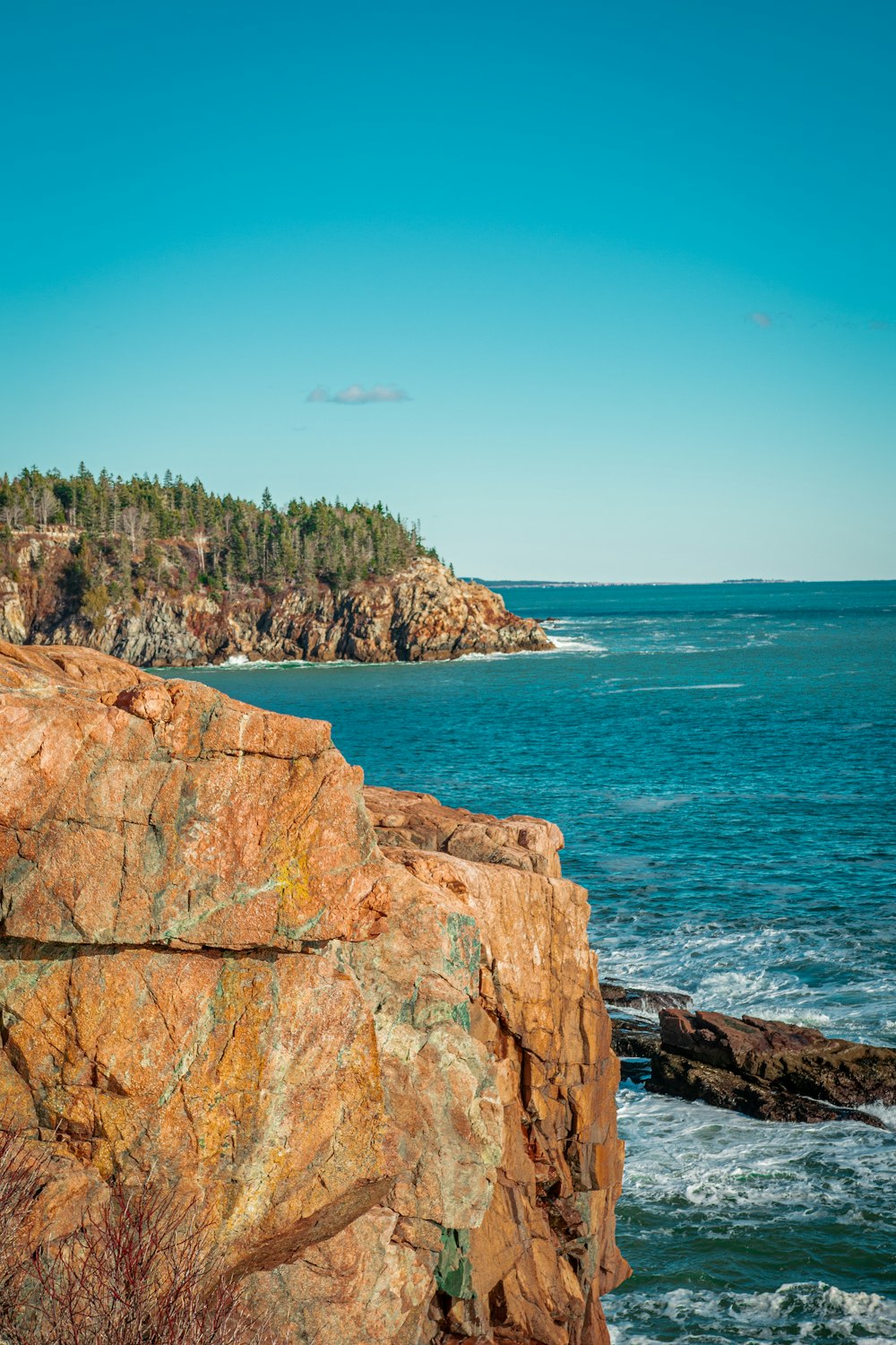 brown rock formation near body of water during daytime