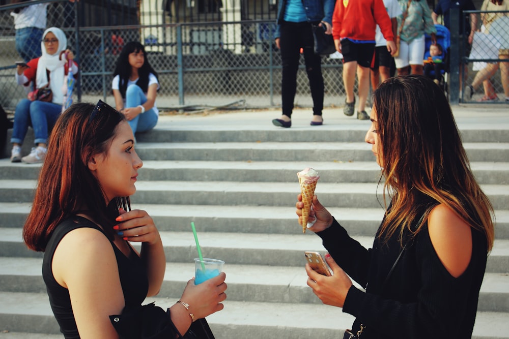 woman in black tank top holding ice cream cone